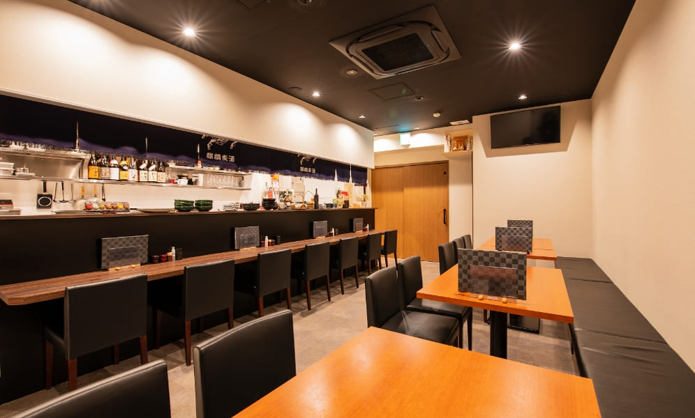テーブル席とカウンター席を含む広い店内全景